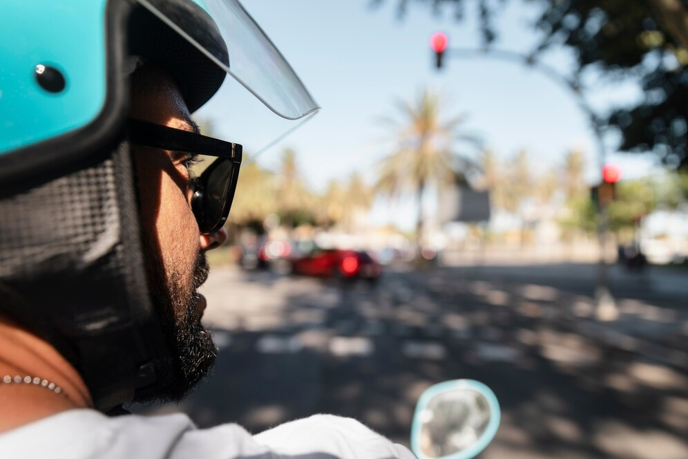 Man driving a motorcycle wearing a helmet