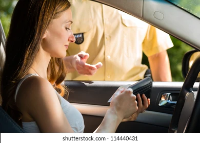 Female handing ID to the police