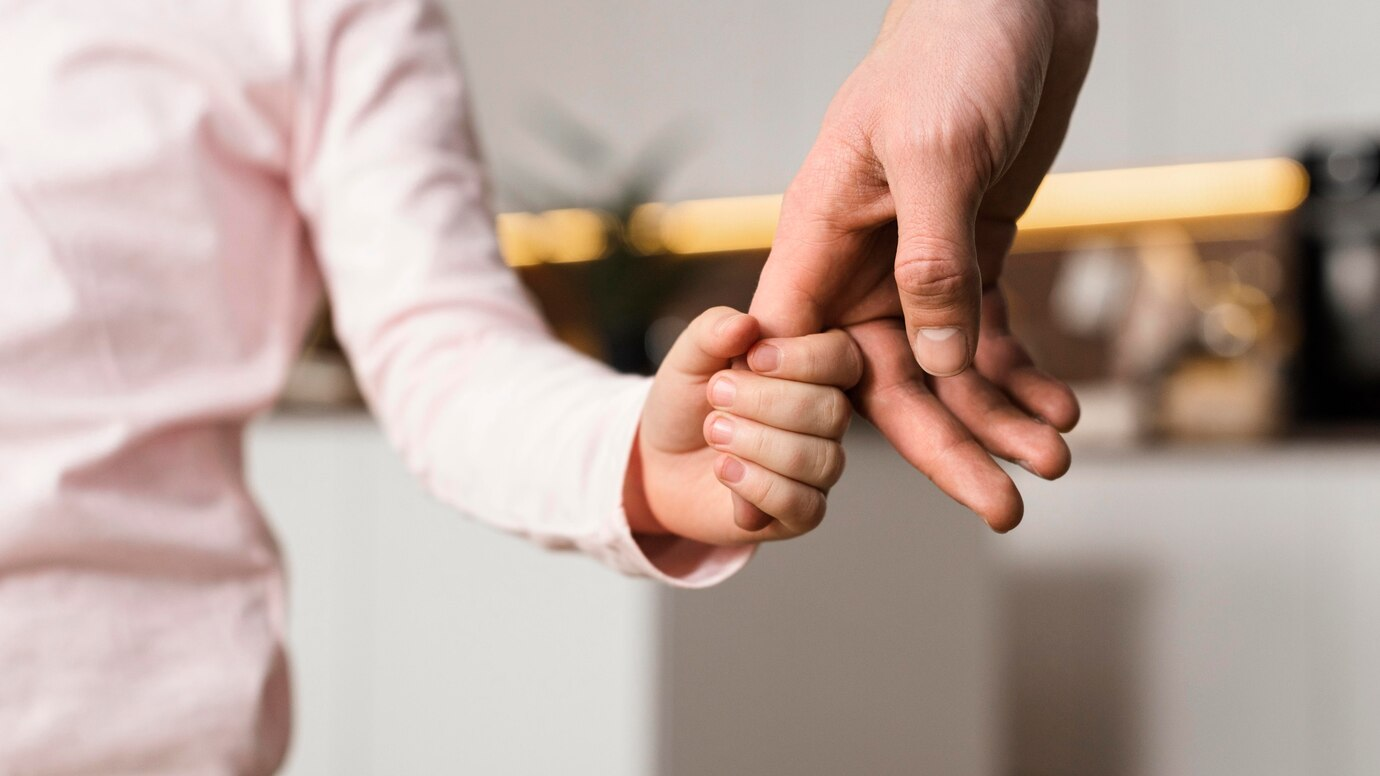 Kid and parent holding hands