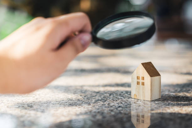 Magnifying glass focused on a miniature house